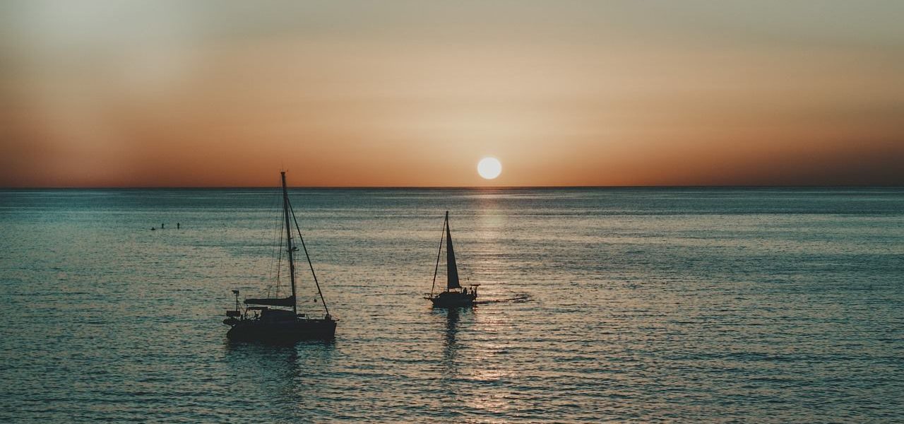 Segelboote vor der Küste von Galdar bei Sonnenuntergang